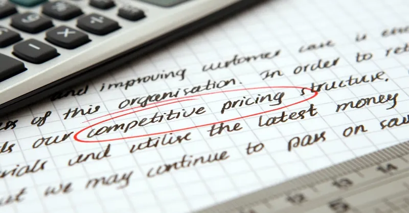 Focused image of handwritten business notes with calculator emphasizing pricing strategy.