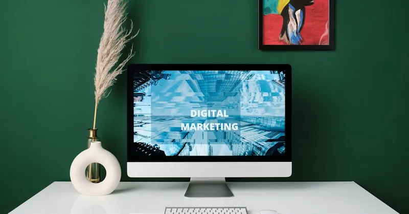 A contemporary office desk with computer screen showcasing digital marketing content.