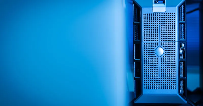 Close-up of a modern server unit in a blue-lit data center environment.