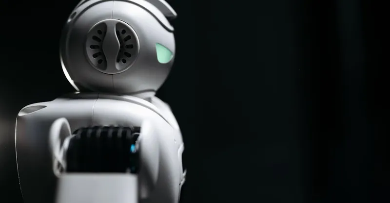 Close-up of a futuristic robot in a dark studio setting, showcasing innovation and technology.