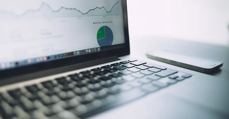 A laptop showing an analytics dashboard with charts and graphs, symbolizing modern data analysis tools.