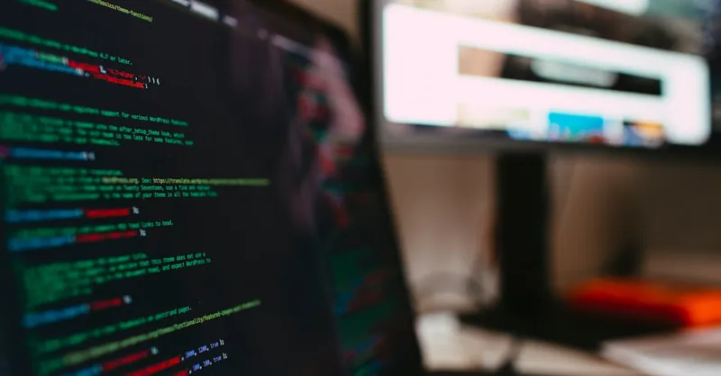 A detailed view of programming code displayed on a laptop screen, depicting a tech workspace.