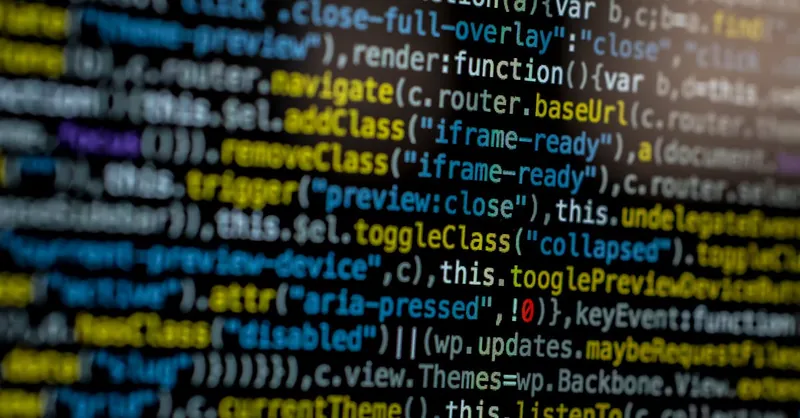 An extreme close-up of colorful programming code on a computer screen, showcasing development and software debugging.