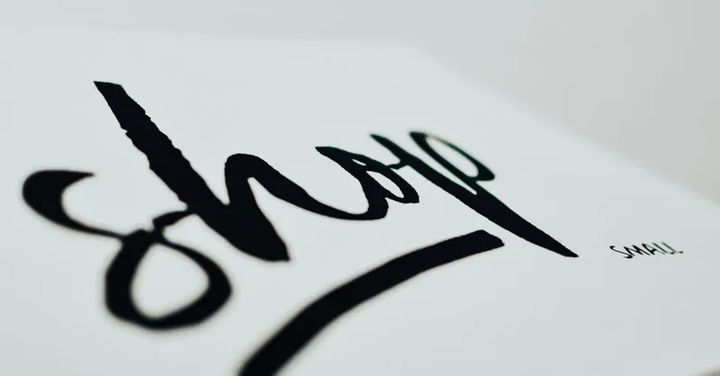 Close-up of a handwritten sign promoting support for small businesses.