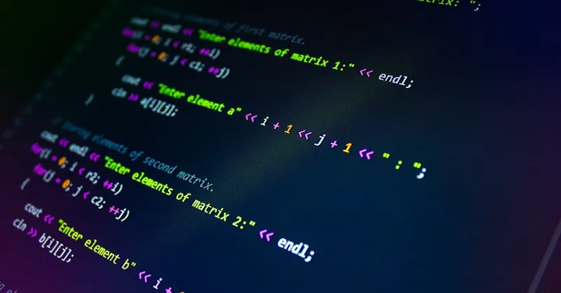 Close-up of colorful programming code displayed on a monitor screen.