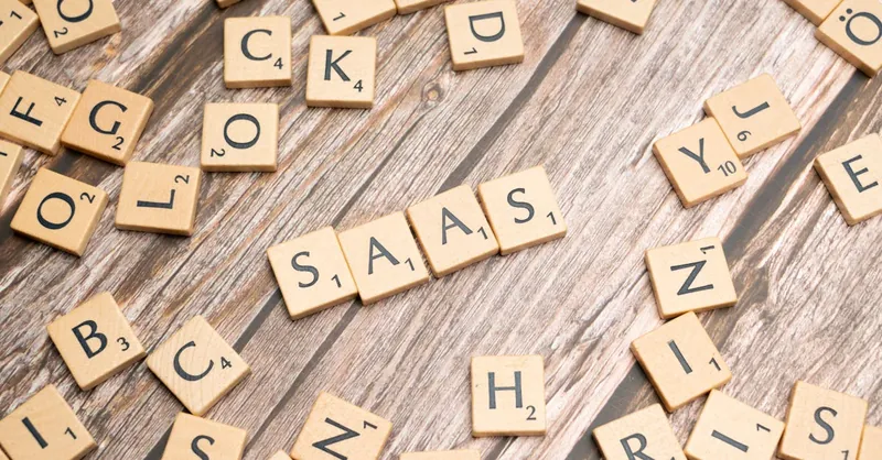 Wooden letter tiles spelling SaaS on rustic wood. Ideal for cloud computing and business concepts.